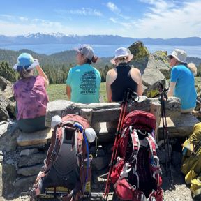 Hikers looking over Lake Tahoe on guided backpacking trips with the Tahoe Rim Trail Association